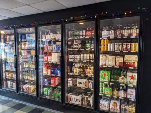 A refrigerator full of beer and other beverages.